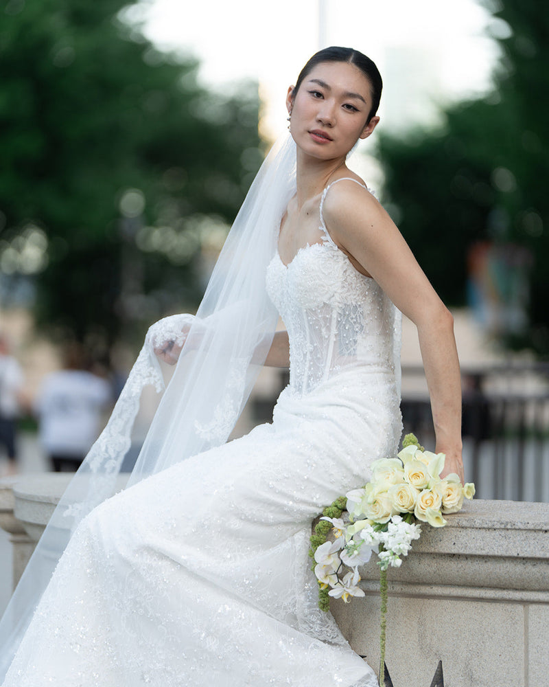 Bride holding cascading orchid bouquet, Chicago wedding florist