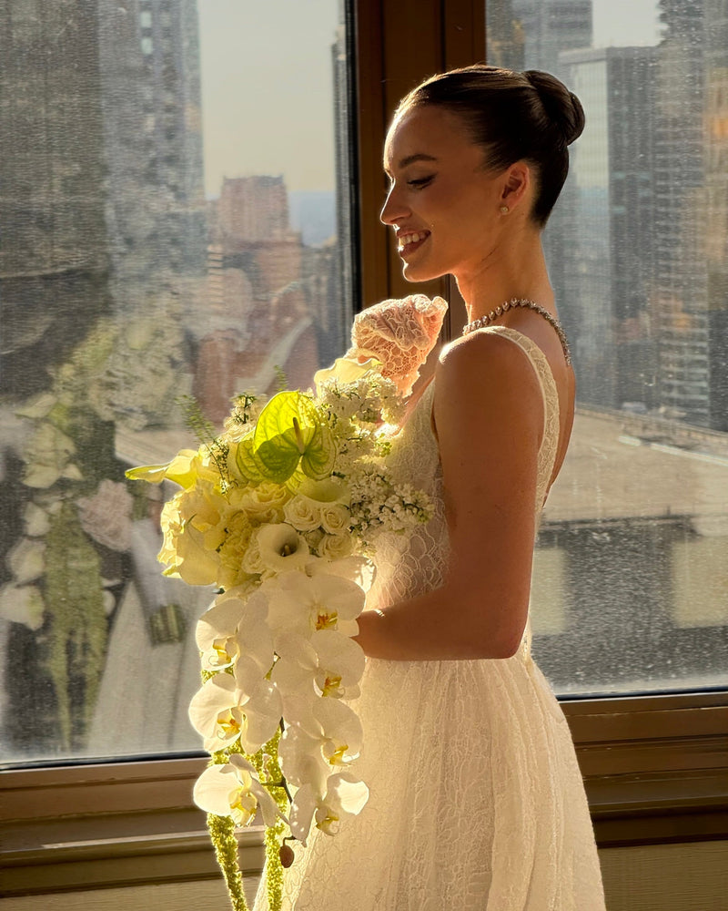 Bride holding cascading orchid bouquet, Chicago wedding florist